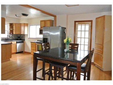 Spacious, open dining area with rich hardwood floo
