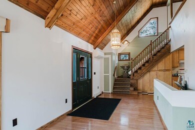 Entryway with high vaulted ceiling, beamed ceiling