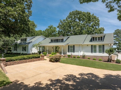 View of front of house with a porch and a front la