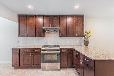 Kitchen with stainless steel gas range oven