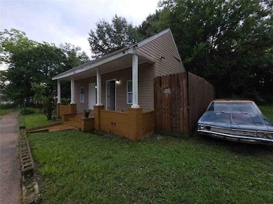 Bungalow featuring covered porch and a front lawn