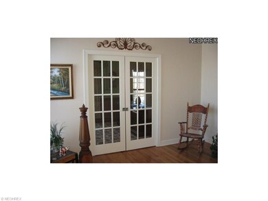 ENTRY TO OFFICE HAS GLASS PANEL POCKET DOORS