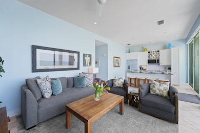 Relax in the elegantly furnished living room, where floor-to-ceiling windows frame panoramic Gulf views. A bird-watcher’s dream, this space offers front-row seats to pelicans soaring and shrimp boats drifting by.