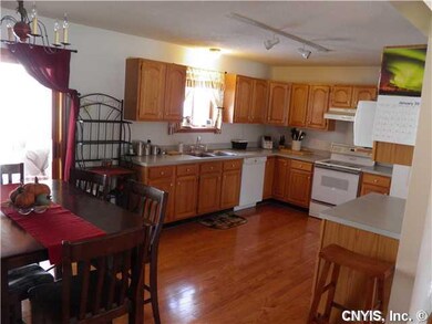 Kitchen. Steps Down thru the Sliding Door to Enclo