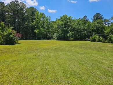 View of green lawn with a view of trees