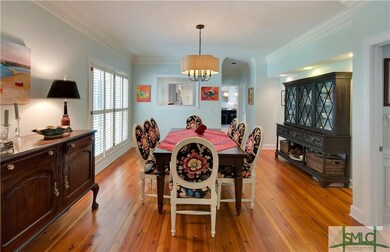 Crown molding and pinewood floors flow through the