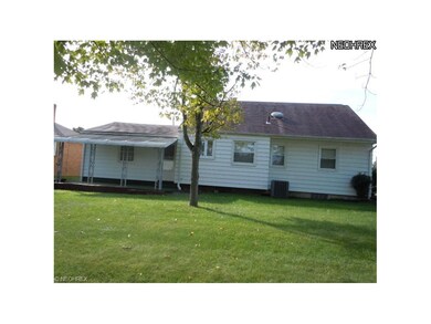 View of back yard with covered patio.