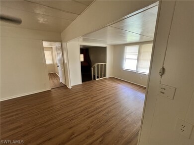 Unfurnished living room with dark hardwood / wood-style flooring