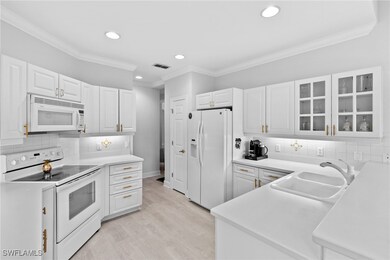 Kitchen featuring sink, white appliances, ornament