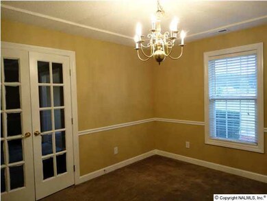The Dining Room is located off the entry way and the Kitchen. French doors open into the Family Room.
