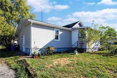 Rear view of house with a yard