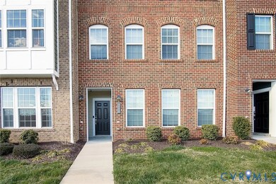 View of exterior entry with brick siding