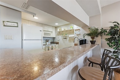 Kitchen with a breakfast bar area, recessed lighti