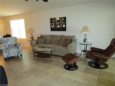 Living area with tile patterned floors, baseboards