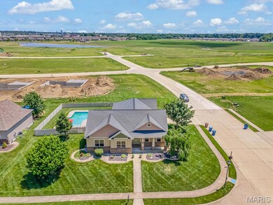 Aerial view of property and surrounding area with a nearby body of water and a local golf course