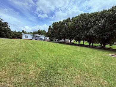Front Yard View from road with tree lined driveway