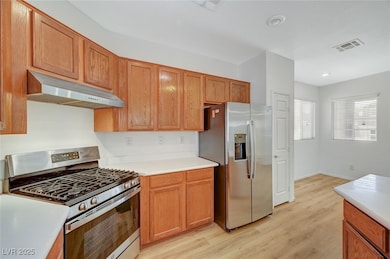 Kitchen featuring visible vents, under cabinet ran