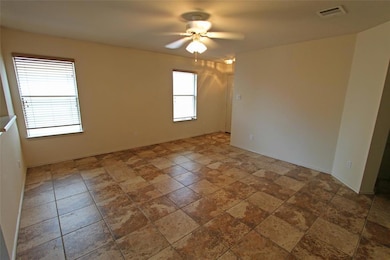 Unfurnished room with ceiling fan and stone finis