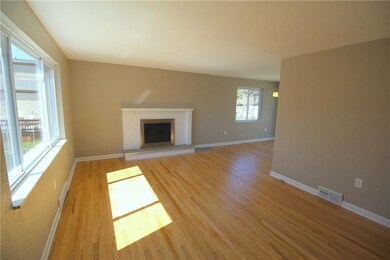 Living room features exposed wood floors and a fir