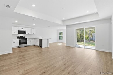 Living room facing the kitchen to the left and dining area to the right