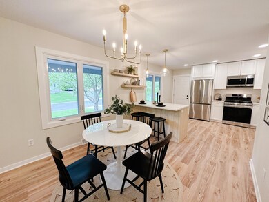 White oak center island/peninsula with trash rollout and exposed shelving for added storage and design!