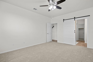 Unfurnished bedroom featuring light colored carpe