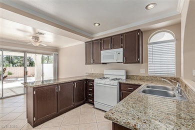 Kitchen featuring white appliances, a peninsula, a