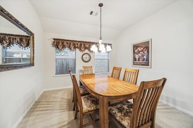 Dining room features a wooden table with six chair