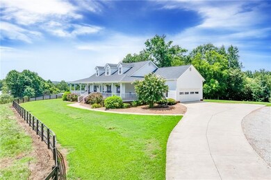 Cape cod-style house featuring covered porch and a