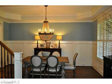 Dining Room. The formal dining room enjoys plantation shutters and a handsome rusticated hardwood floor.