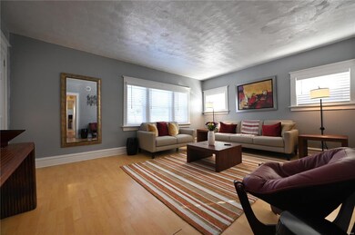 Living room with light hardwood / wood-style floors and a textured ceiling