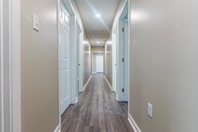 Corridor featuring dark hardwood / wood-style floo