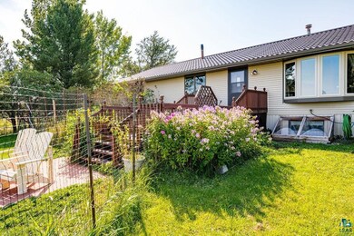 Rear view of property with fence, a deck, and a ya