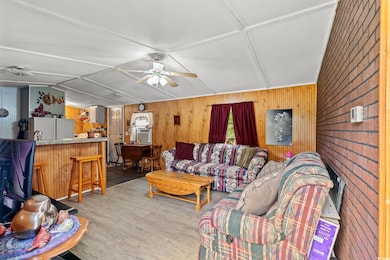 Living room with wood walls, wood finished floors,