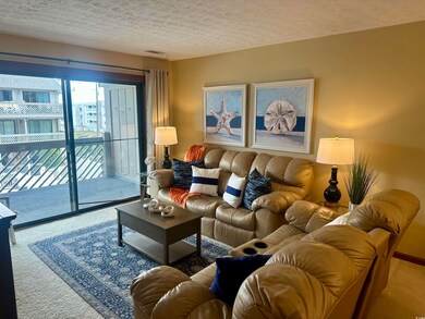 Living room featuring carpet and a textured ceilin