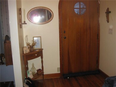 Beautiful hardwood front door entry coupled with h