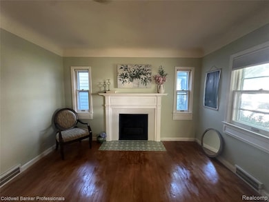 Unfurnished living room with a fireplace with flush hearth and dark wood-style floors
