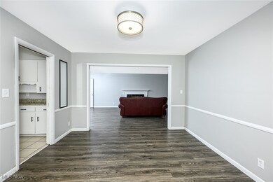 Hall featuring dark wood-style floors and baseboards