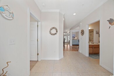 Hallway with light tile patterned flooring and cro