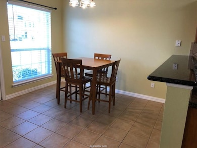 Dining space featuring light tile patterned floors