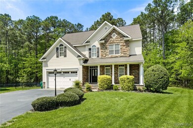 View of front of property featuring fence, a garag
