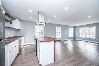 Kitchen featuring butcher block counters, light wo