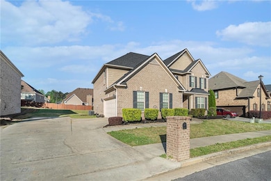 View of front of property with a garage, fence, a 