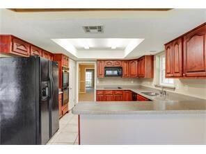 Plenty of counter tops and cabinets - and a breakf
