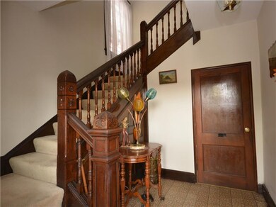 Entry features beautiful original railing and judg