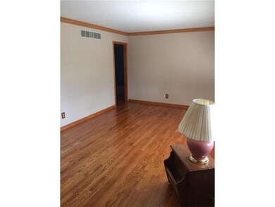 Beautiful hardwood refinish in the living room.  N