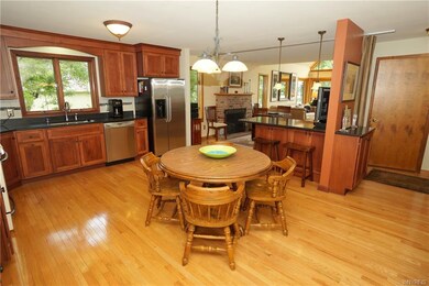 Large eat in kitchen with custom cabinetry, stainl