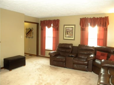Living room off of entry way and dining room.