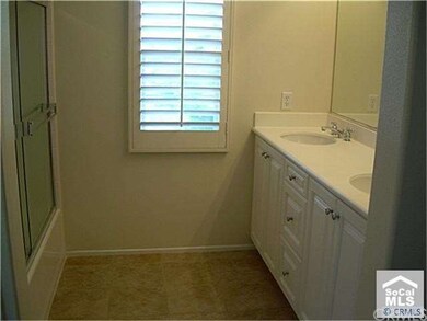 Master bath with plantation shutter, two sinks wit