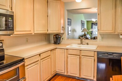 Eat-in kitchen with a serving window and hardwood 